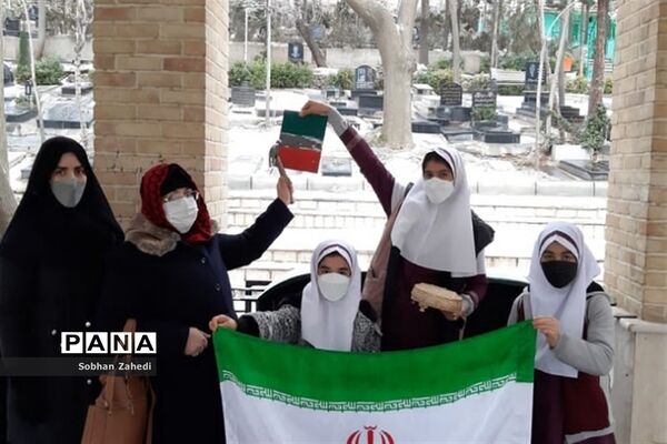 غبارروبی مزارشهدا توسط دانش‌آموزان رودهن در دهه فجر